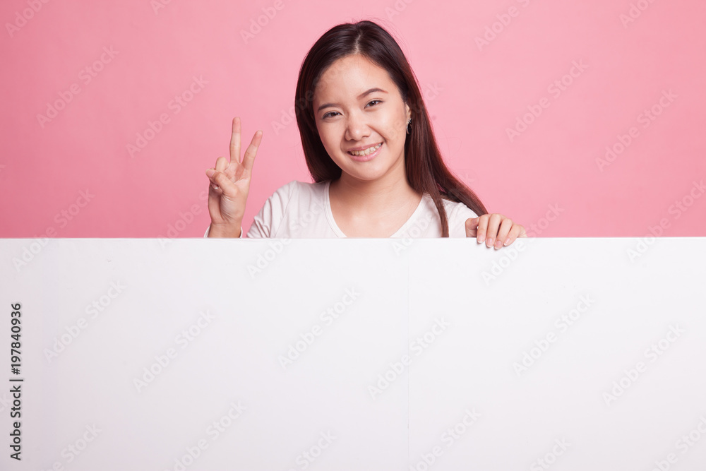 Young Asian woman show victory sign with blank sign. Young Asian woman show victory sign with blank sign.