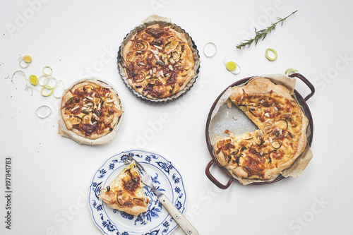 different delicious quiches on a wooden background