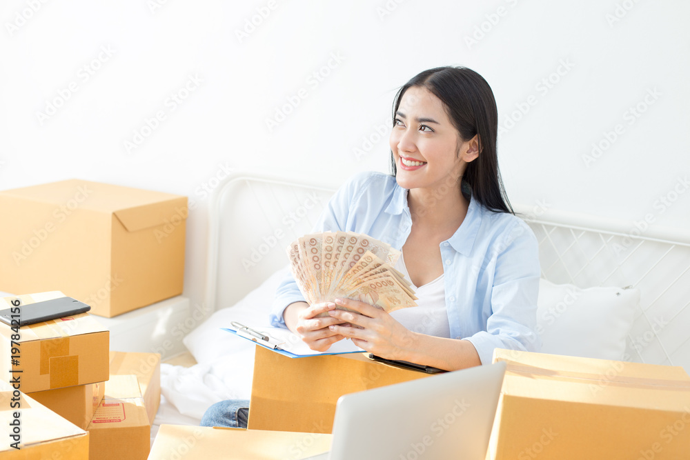 Young Asian Woman Working at home, Young Owner Woman Start up for Business Online. People with online shopping SME entrepreneur or freelance working concept. Young Asian Woman Working at home, Young Owner Woman Start up for Business Online. People with online shopping SME entrepreneur or freelance working concept.