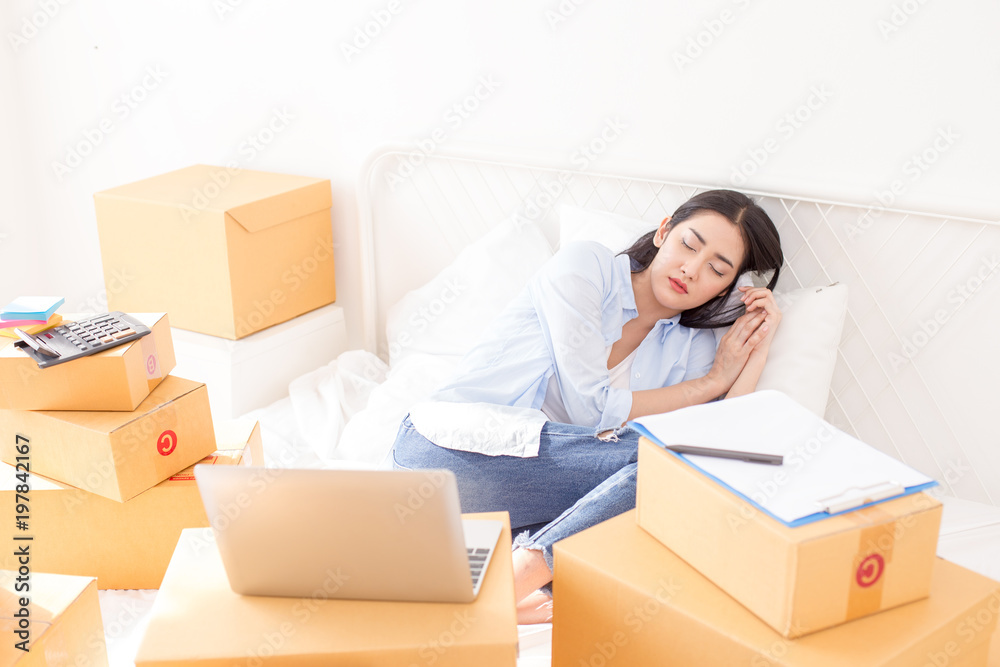 Young Asian Woman sleep while Working at home, Young Owner Woman Start up for Business Online. People with online shopping SME entrepreneur or freelance working concept. Young Asian Woman sleep while Working at home, Young Owner Woman Start up for Business Online. People with online shopping SME entrepreneur or freelance working concept.