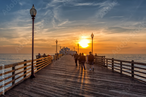 Canvas Print People walking on Oceanside pier at sunse, California