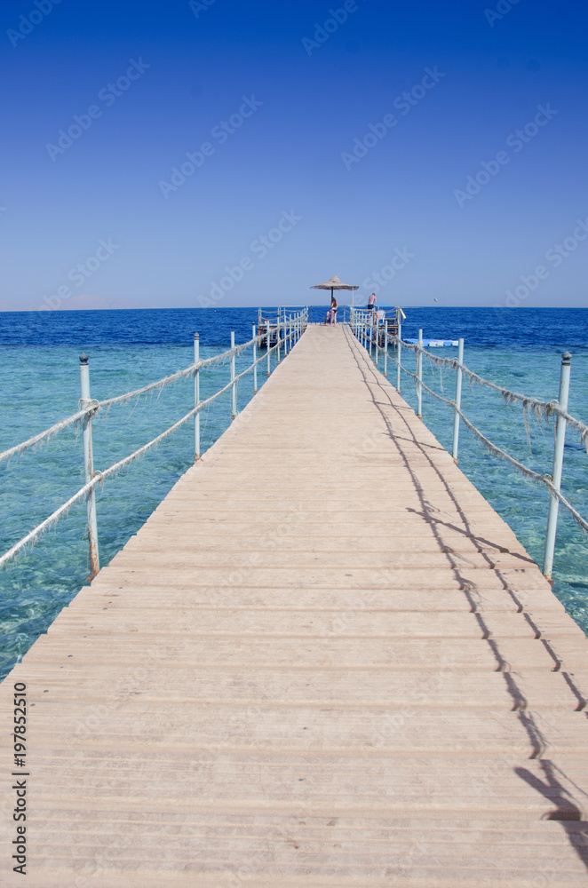 Obraz premium Wooden bridge over the sea. Travel and Vacation. Red sea, Sharm El-Sheikh