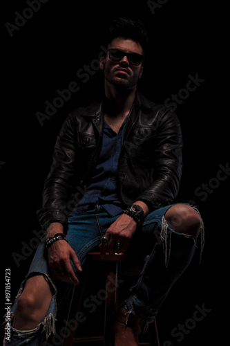 seated fashion man with sunglasses posing seductively © Viorel Sima