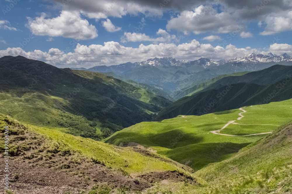 Scenic view of Hevsureti, Georgia. Caucasus mountains on the background, green valley on the foregound. Hot summer day. Concept of clear ecosystem.