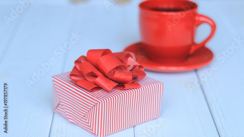 close-up background image of red Cup and gift box on light background.
