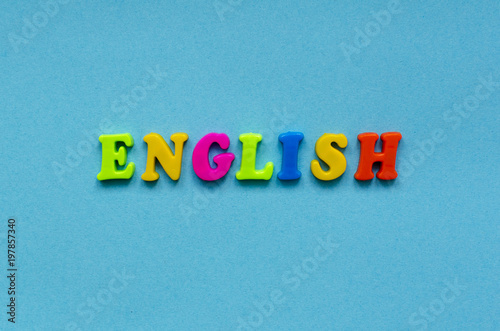 word "english" of colored plastic magnetic letters on blue paper background