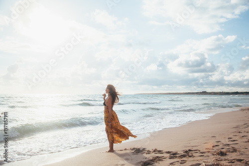 Boho girl walking on the beach