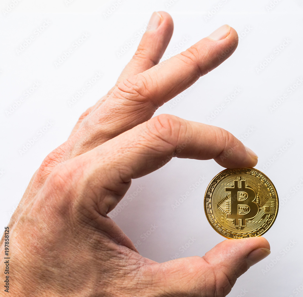 Hand holding golden Bitcoin virtual money Hand holding golden Bitcoin virtual money