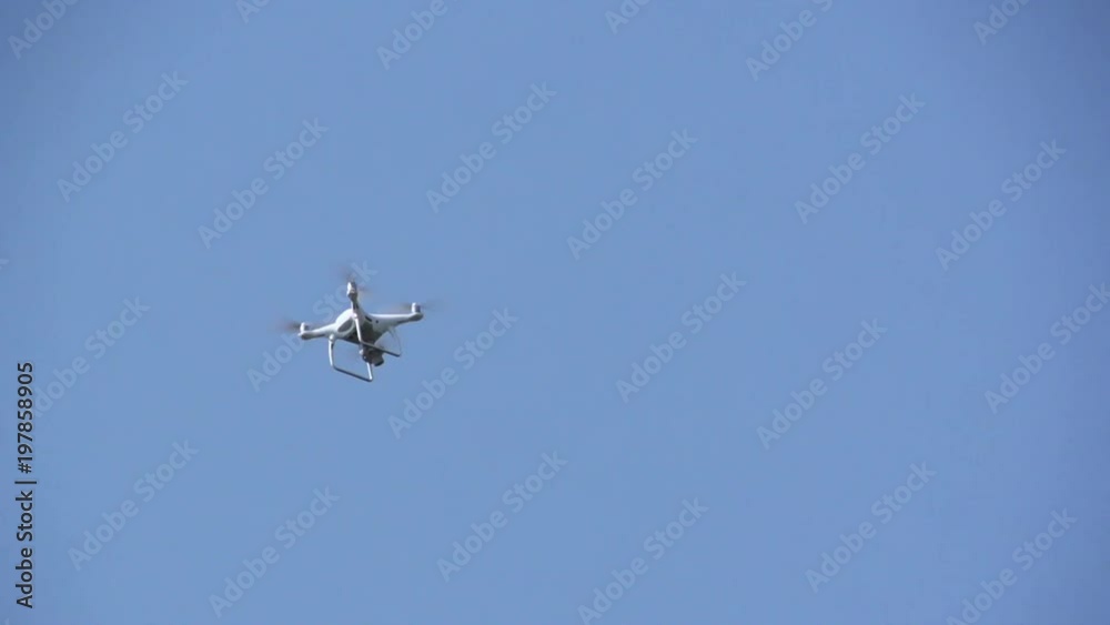 White drone, quadrocopter with photo camera flying concept White drone, quadrocopter with photo camera flying concept
