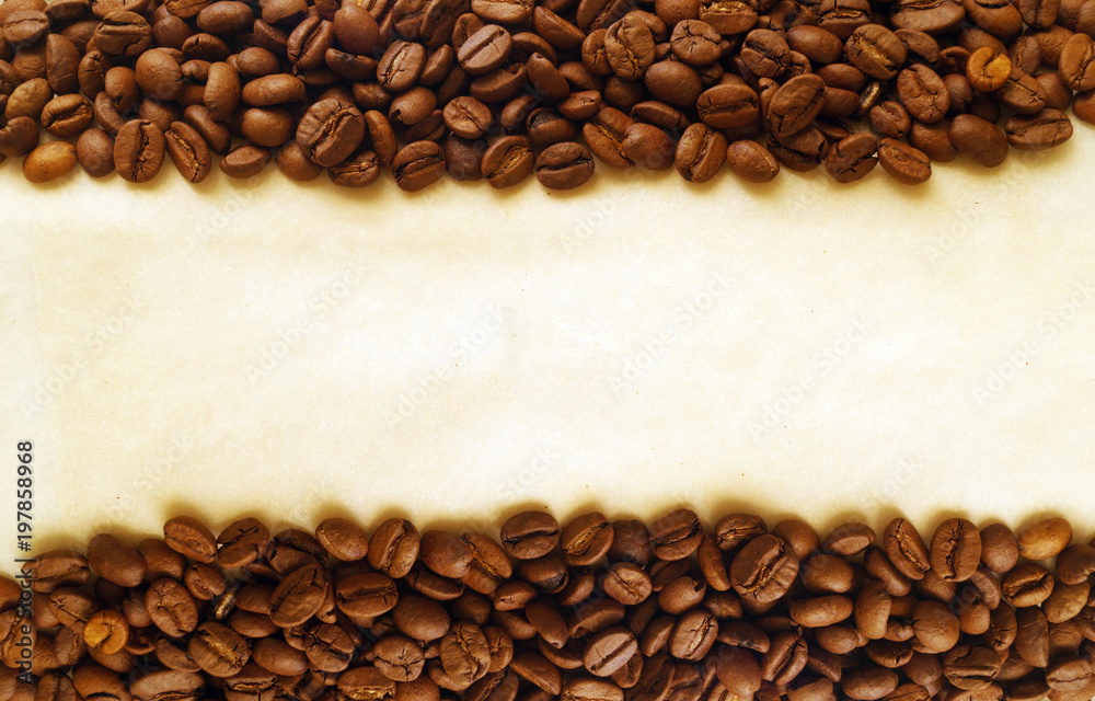Coffee beans on old burnt paper background