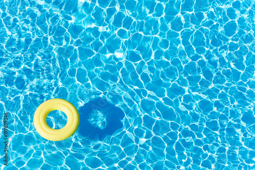 Fotografie, Obraz Empty rubber ring floating on blue water surface