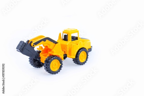 Toy construction vehicles Excavator industrial machine doing construction new road earthworks on white background © Luis2499