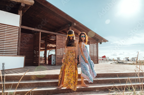 Boho girls walking on the beach photo