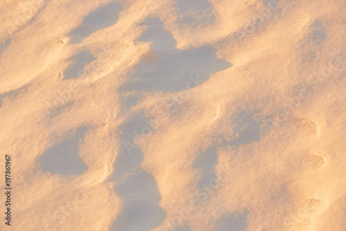 light and shadow on the snow in the golden hour. background.