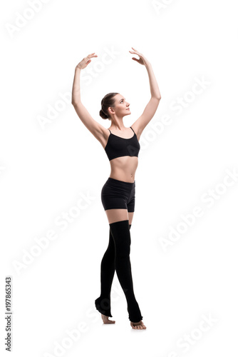 Slim girl in black sportswear dancing shot