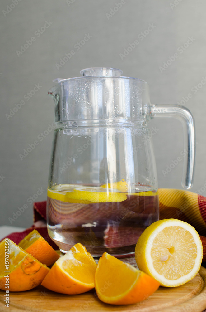Obraz premium Fresh drink, glass jar with water and fruits