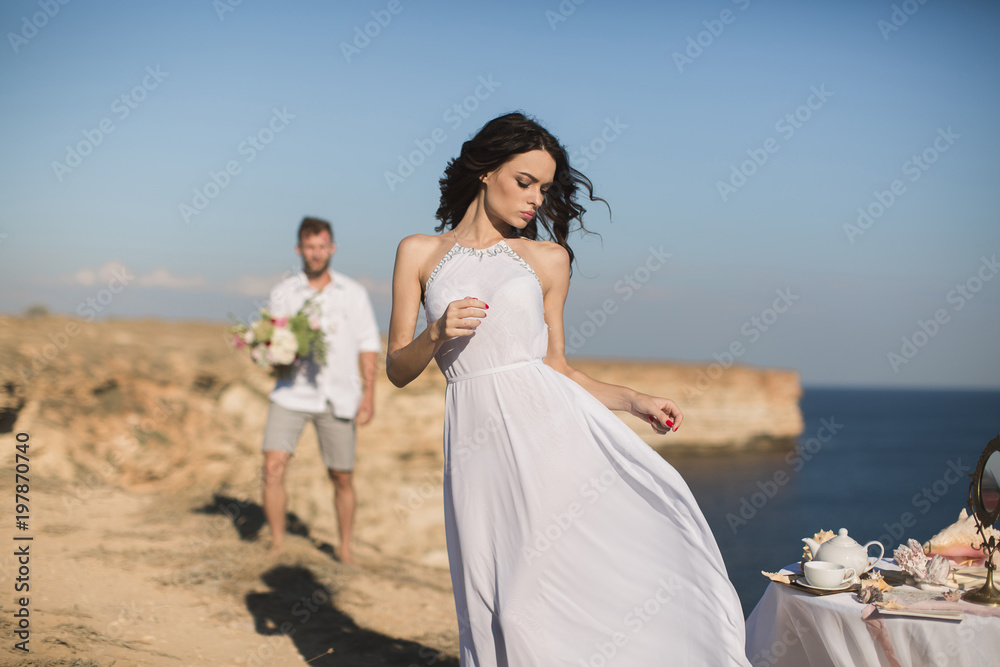 Beautiful young couple on a date. The guy brings flowers. Beautiful young couple on a date. The guy brings flowers.