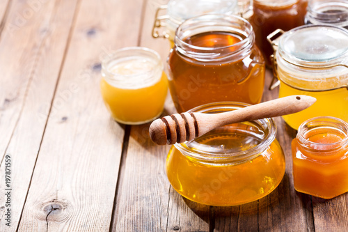 various types of honey in glass jars