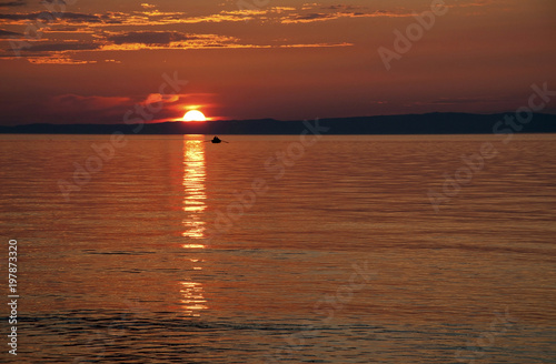 Sanset on Lake Baikal with a boat. photo