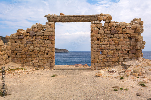 Canvas Print The ruins of an ancient building in the picturesque village of Firopotamos on Milos Island