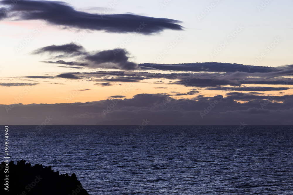 Colorful sky with intersting shaped clouds over the Atlantic Ocean at dawn Colorful sky with intersting shaped clouds over the Atlantic Ocean at dawn