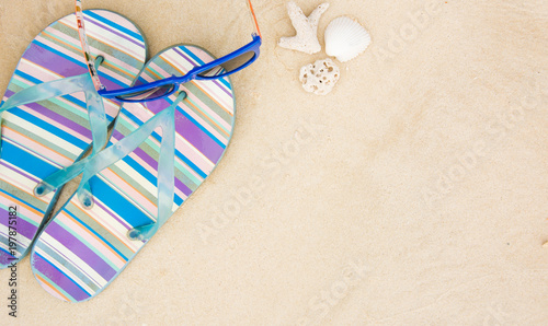 Summer time on seashore, seashell, sunglasses and flip flops
