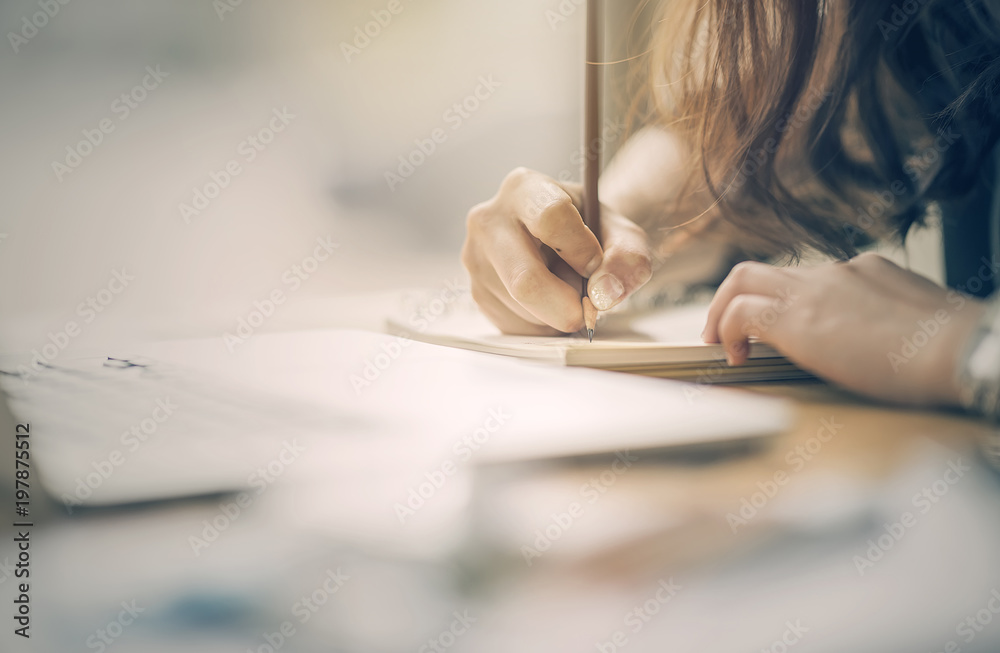 Close up of female designer hands at workplace drawing something with pencil Close up of female designer hands at workplace drawing something with pencil