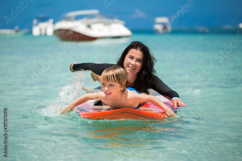 Sticker Mom and son have surfing in the ocean on the blackboard