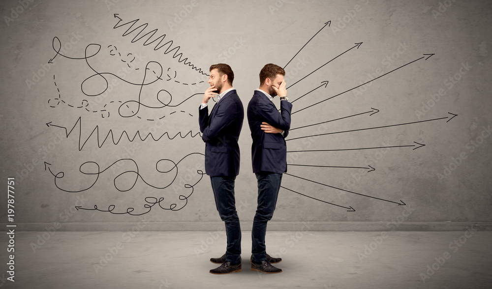Young conflicted businessman choosing between two directions with arrows and scribbles around him Young conflicted businessman choosing between two directions with arrows and scribbles around him