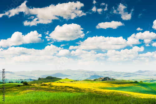 Tuscany landscape, Italy. Green fields and the blue sky.
