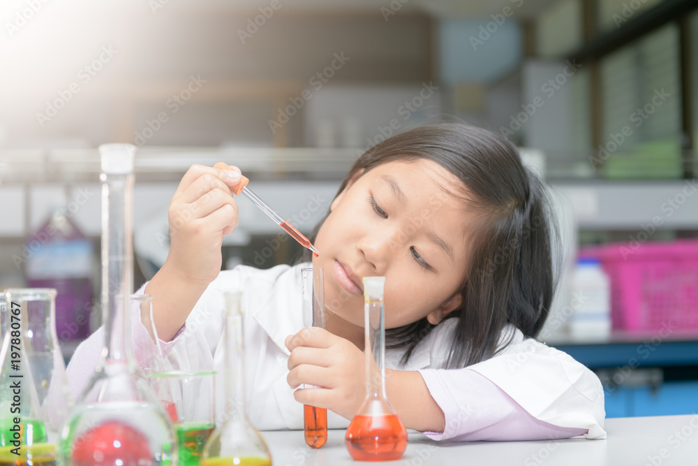 student in lab coat making experiment with test tube student in lab coat making experiment with test tube
