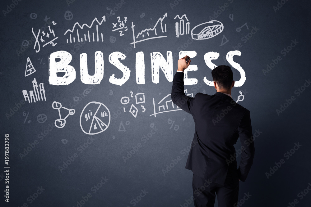 Young businessman in black suit standing in front of a detailed business plan Young businessman in black suit standing in front of a detailed business plan
