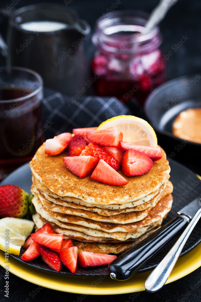 Stack of freshly prepared lemon poppy seed pancakes with fresh strawberry Stack of freshly prepared lemon poppy seed pancakes with fresh strawberry