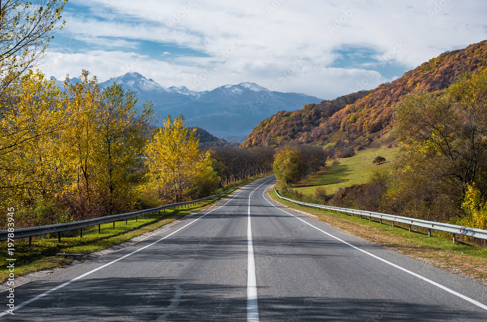 Road leads to cloud covered mountains in th autumn. Road leads to cloud covered mountains in th autumn.