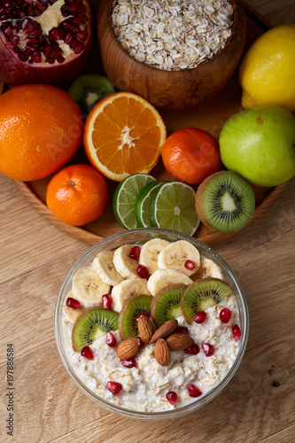 Breakfast still life with oatmeal porridge and fruits, top view, selective focus, shallow depth of field.