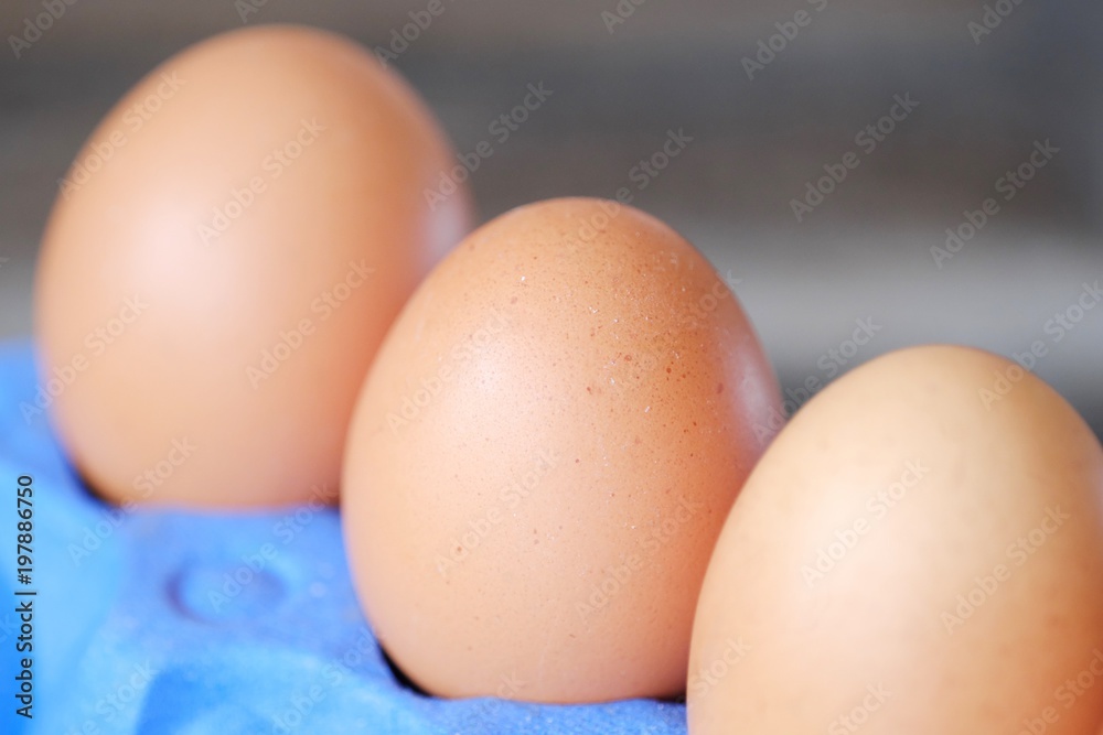 Chicken eggs in the purple package on the table Chicken eggs in the purple package on the table