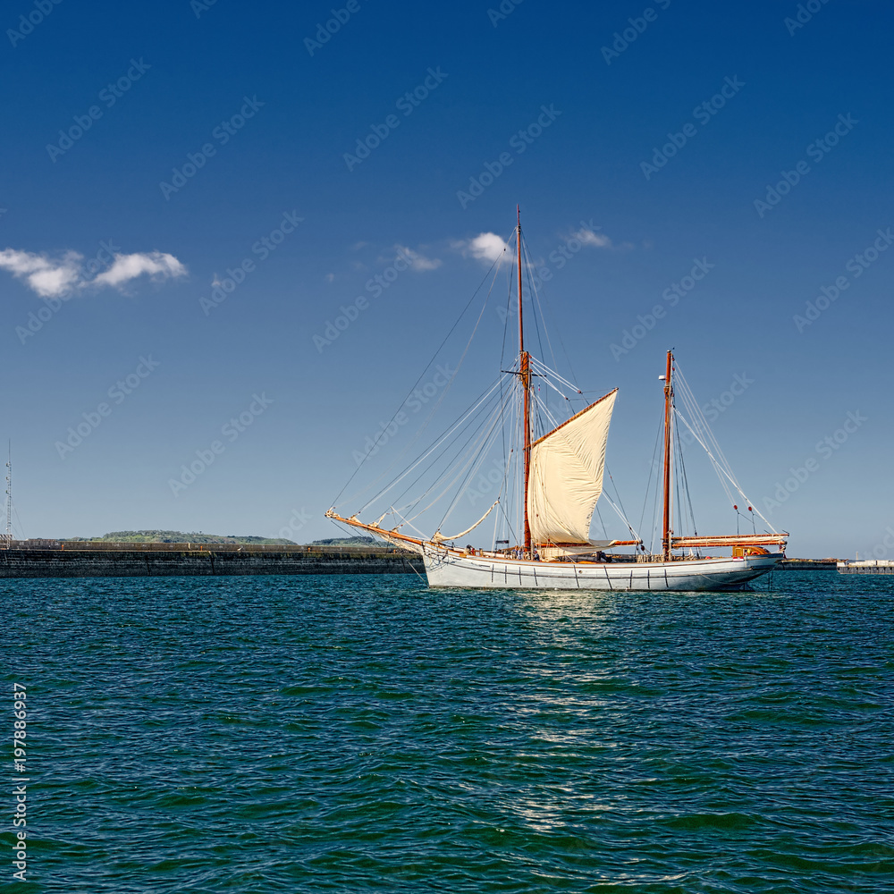 Sailing ship in the blue sea under sail. Yachting. Sailing