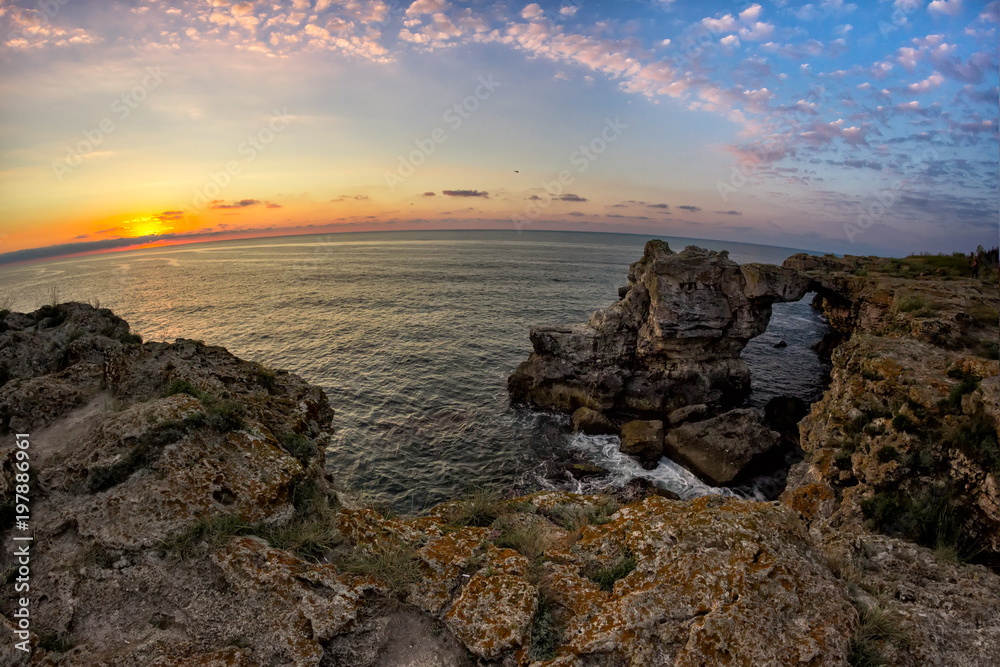Beautiful sunrise over the Black Sea with rocks on the shore, Tyulenovo, Bulgaria