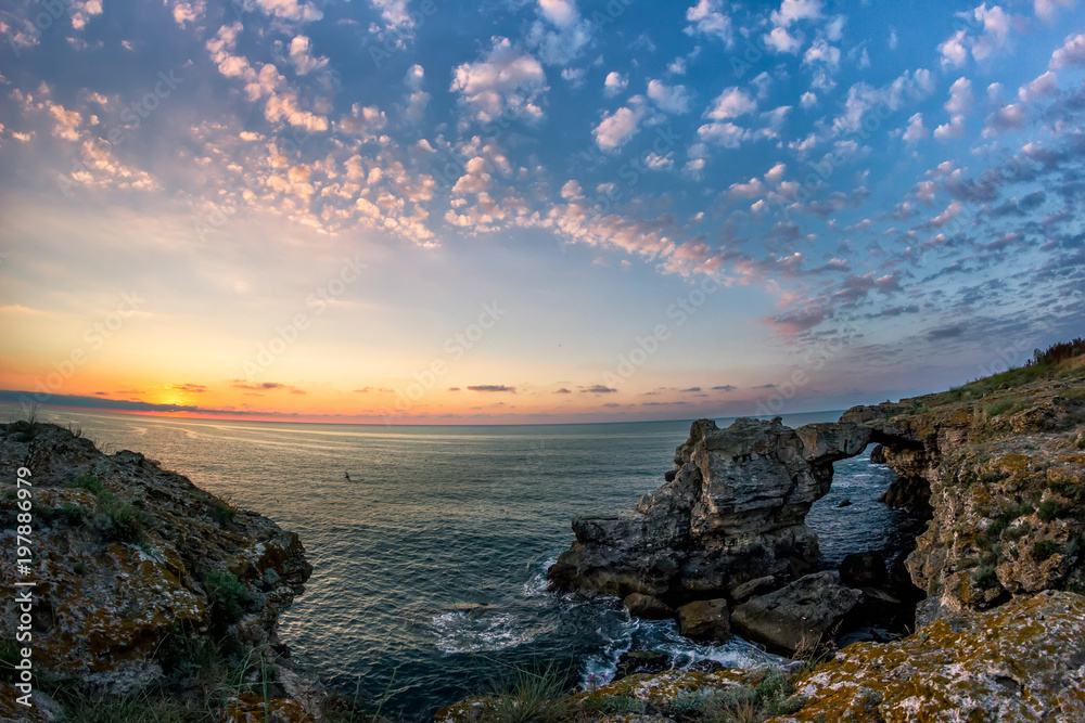 Beautiful sunrise over the Black Sea with rocks on the shore, Tyulenovo, Bulgaria