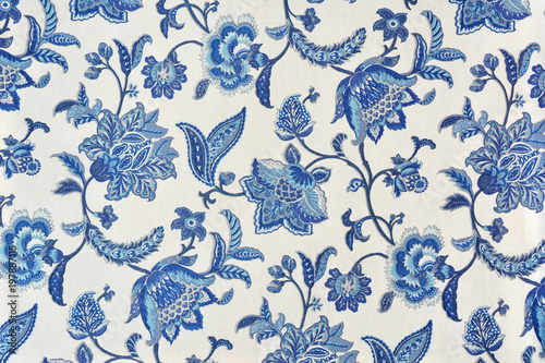 Blue ornate floral pattern on white cotton tablecloth.