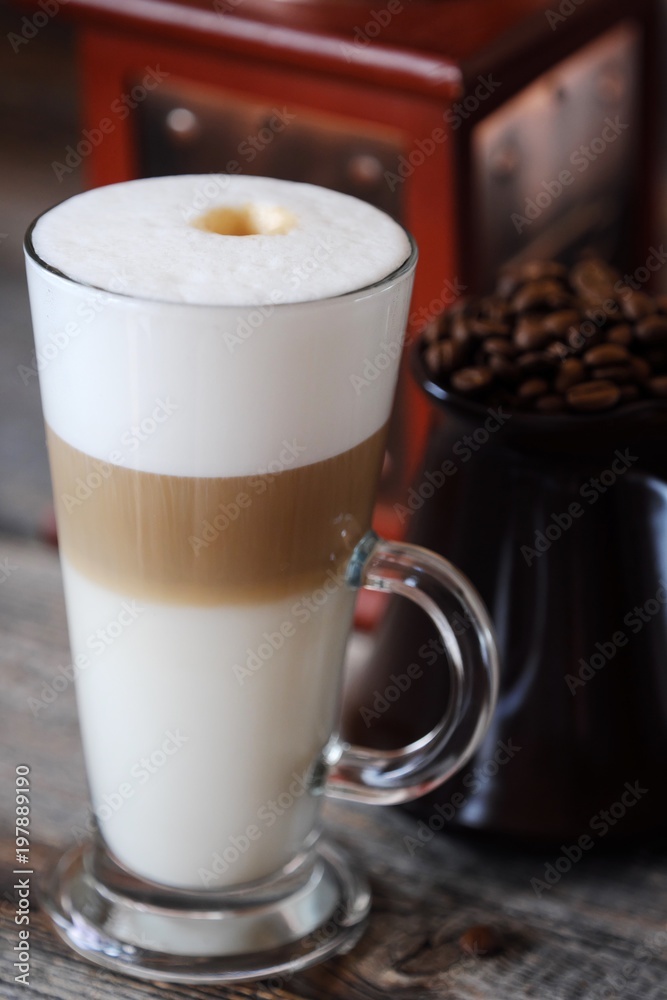 Delicious fresh latte coffee on wooden table Delicious fresh latte coffee on wooden table
