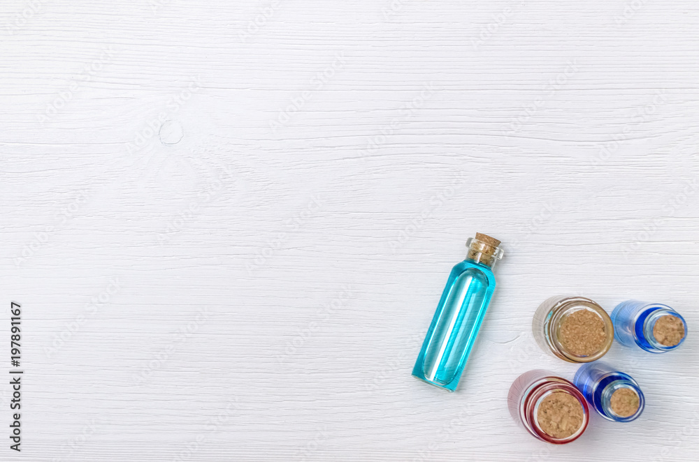 Set of colorful essential oil tinctures on white wooden table background with copy space, top view. Alternative medicine. Set of colorful essential oil tinctures on white wooden table background with copy space, top view. Alternative medicine.