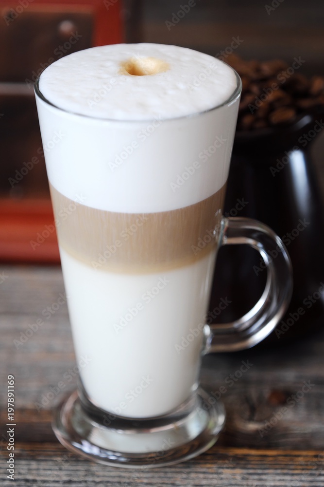 Delicious fresh latte coffee on wooden table Delicious fresh latte coffee on wooden table