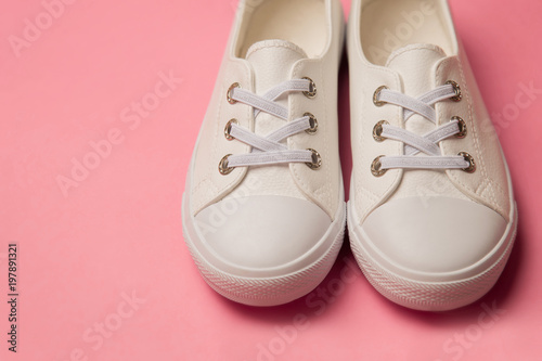 Overhead Shot Of White female Sneakers On Pastel Pink Background