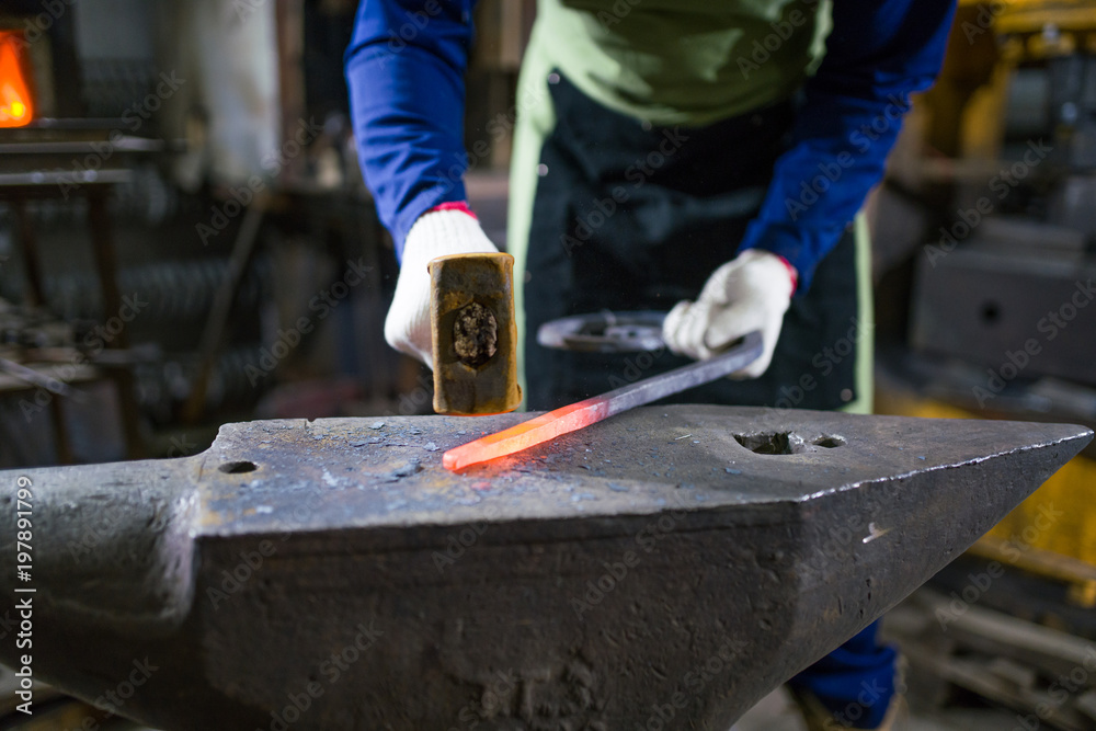 The blacksmith forges the luminous metal in the furnace, kicks out the sparks The blacksmith forges the luminous metal in the furnace, kicks out the sparks