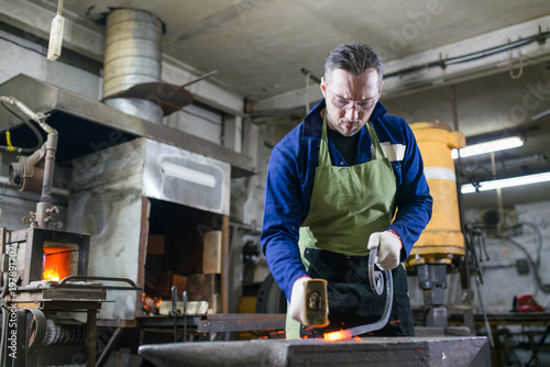 The blacksmith forges the luminous metal in the furnace