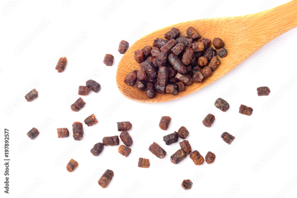 Granules of bee bread in a wooden spoon are isolated on a white background. Apitherapy. Beekeeping products. Strengthening immunity. Granules of bee bread in a wooden spoon are isolated on a white background. Apitherapy. Beekeeping products. Strengthening immunity.