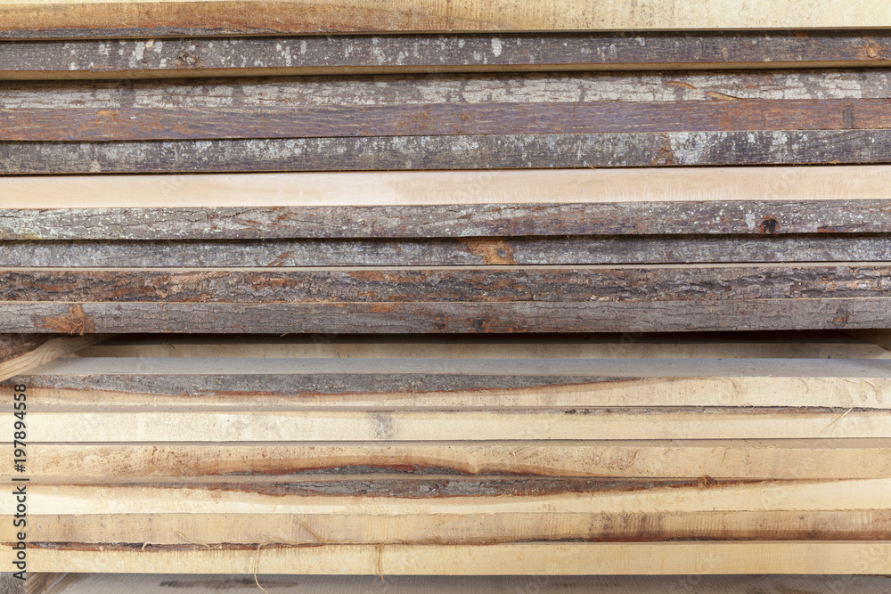 wooden beams stacked in a pile wooden beams stacked in a pile