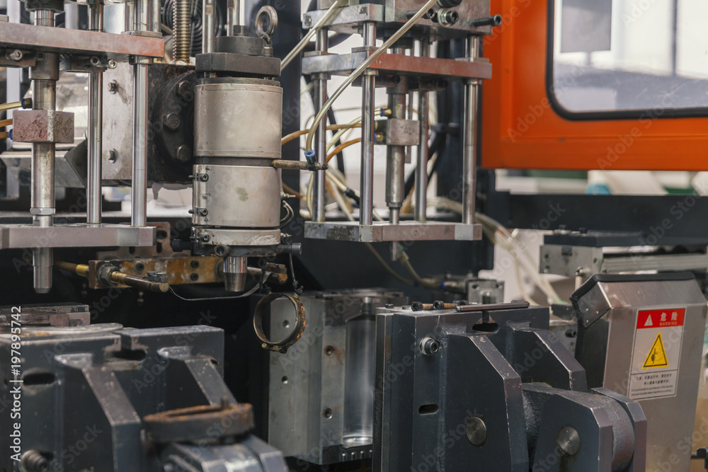 worker repairs a machine for plastic injection worker repairs a machine for plastic injection