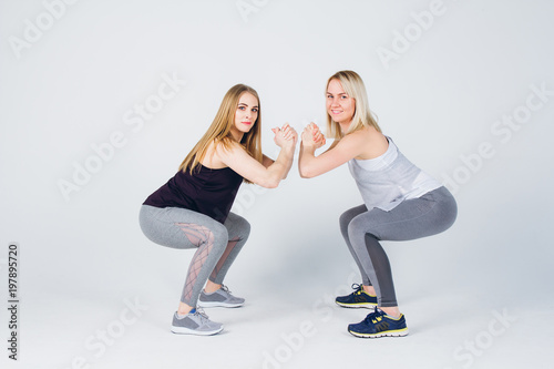 Pregnant girl and her friend are engaged in fitness